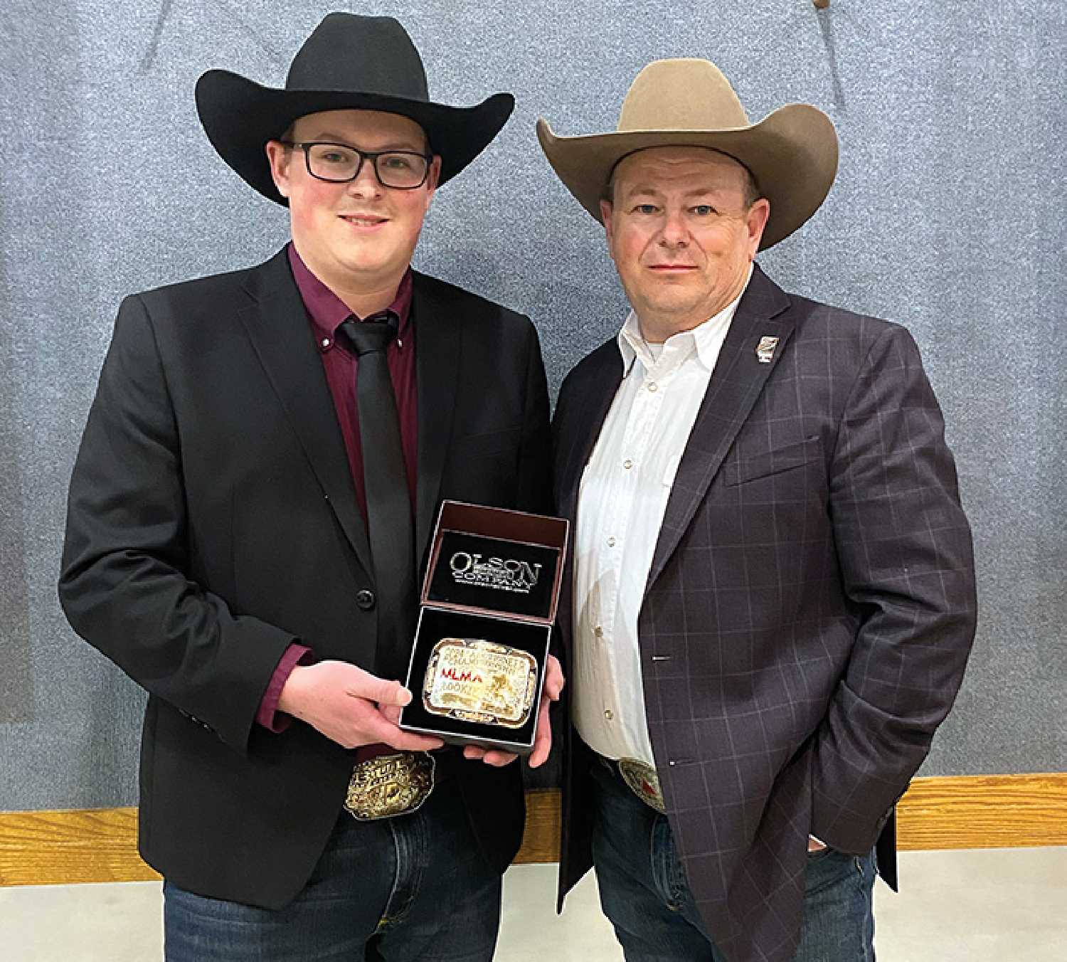 Ty Cutler with his father Ward Cutler at the Man-Sask Auctioneering Competition on March 22. Ty grew up watching his dad auctioneer, and won the Rookie Buckle at the competition.